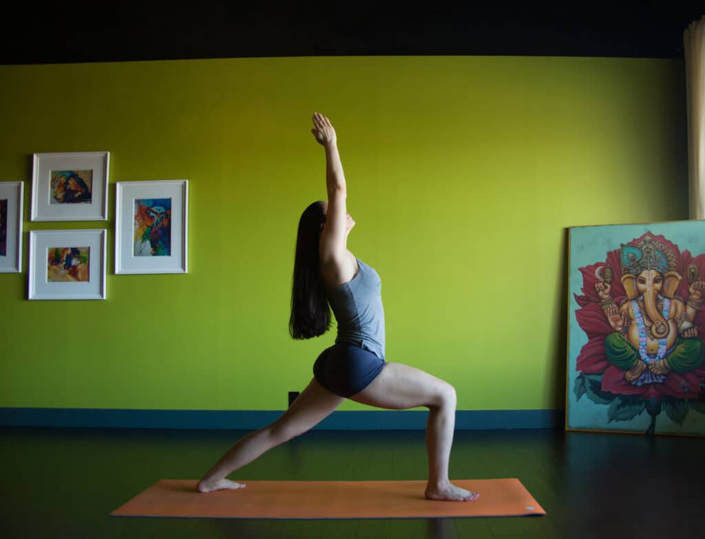 Owner Krista Shirley practices Warrior One standing yoga pose from the Ashtanga Primary Series inside the Yoga Shala at 140 Circle Drive #4 in Maitland, Florida. The studio specializes in the Mysore method under Krista's guidance as a Level Two authorized Ashtanga Yoga teacher.