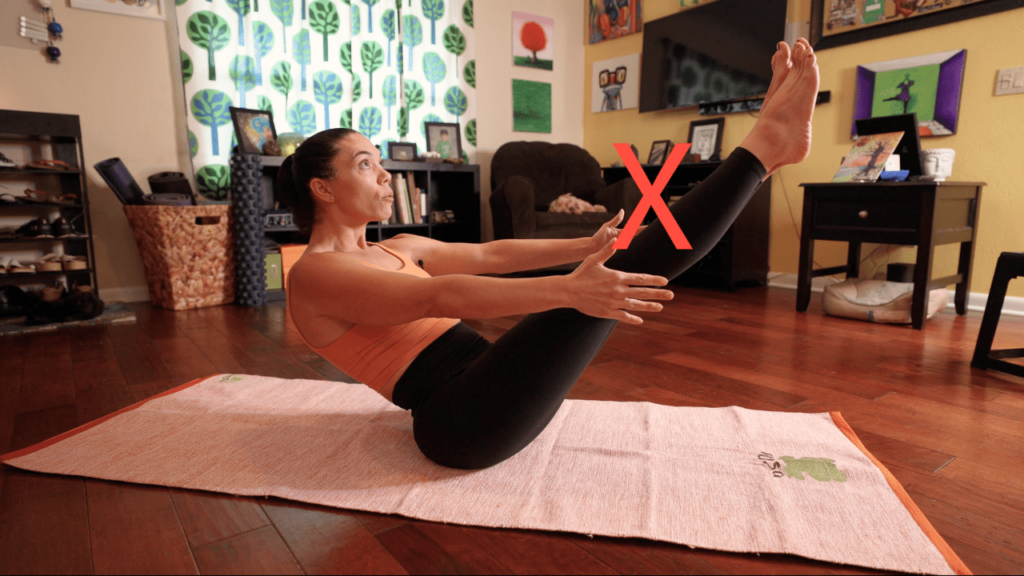 Krista Shirley, a level two authorized Ashtanga Yoga teacher and owner of the Yoga Shala in Maitland, Florida, demonstrating common mistakes in performing Navasana at her house in Orlando. She provides valuable insights on how to correct and improve form in this primary series pose.