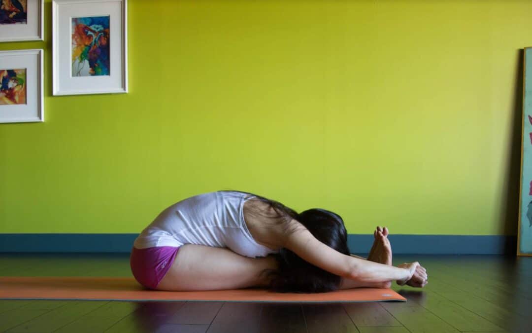 Krista Shirley demonstrates Paschimottanasana, a seated posture in Ashtanga Yoga.